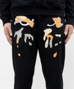 Roku Studio (black/orange” Tear Dripping Jogger)